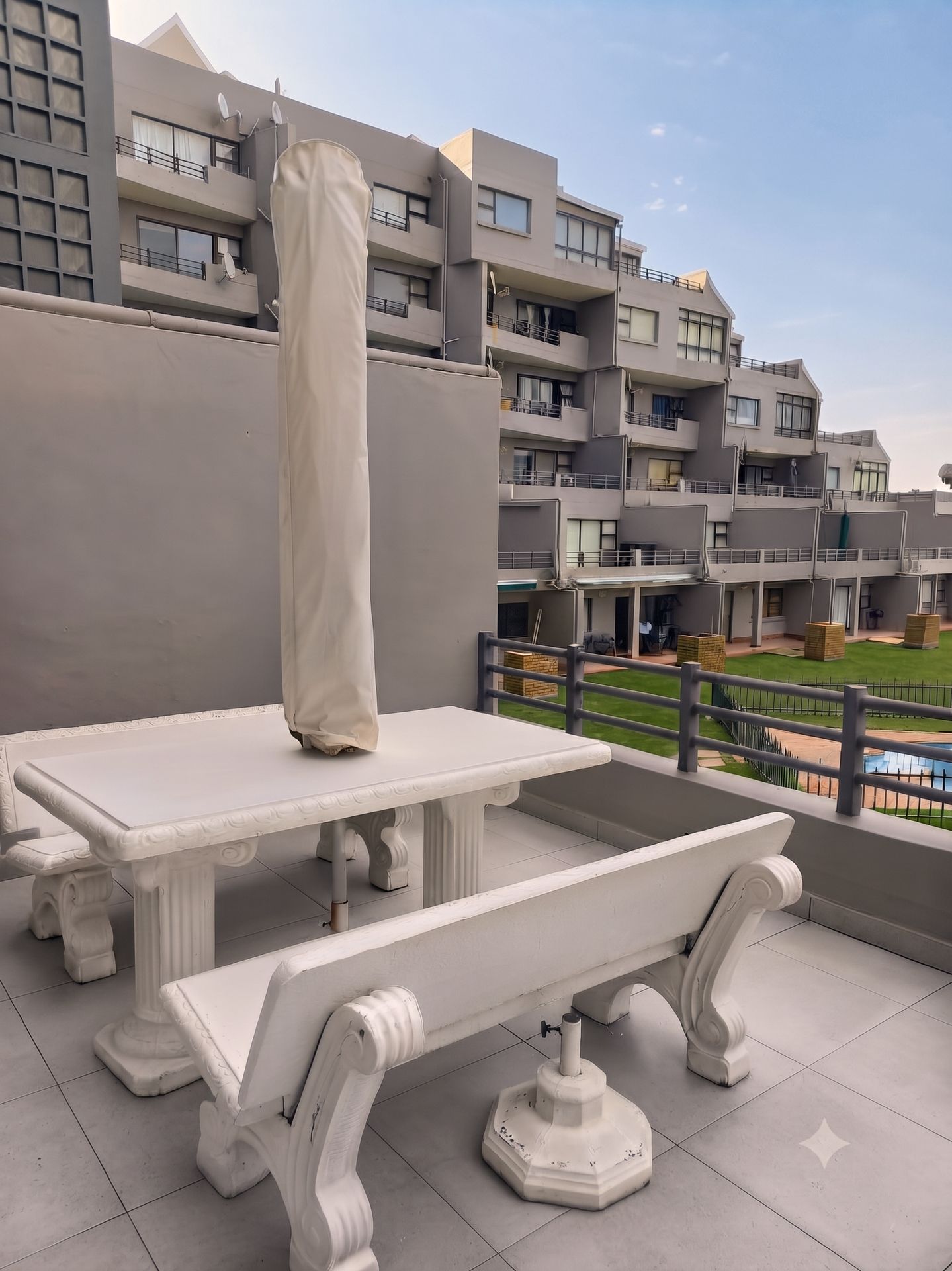 Large open balcony with patio table and seating